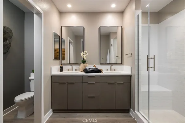 a bathroom with a double vanity sink and mirror