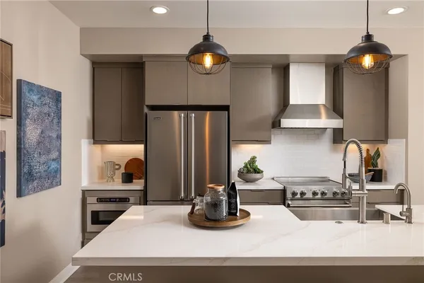 a kitchen with a refrigerator and a stove