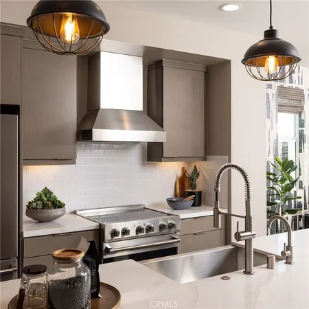 a kitchen with granite countertop a sink stainless steel appliances and dining table