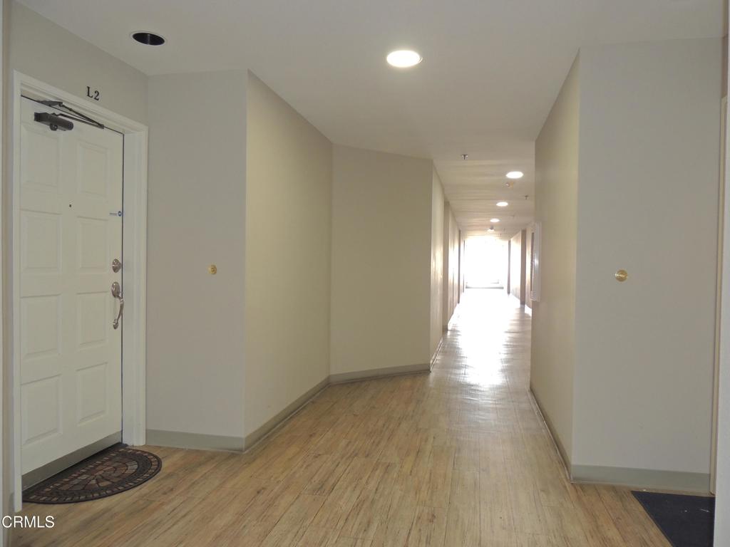 a view of hallway with wooden floor