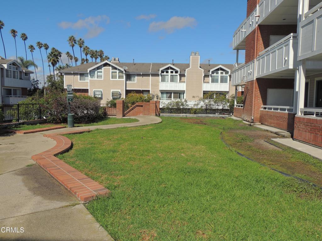 865 South B Street, Unit L2 Oxnard, CA 93030 - Photo 26 of 32 a front view of multiple houses with yard and green space