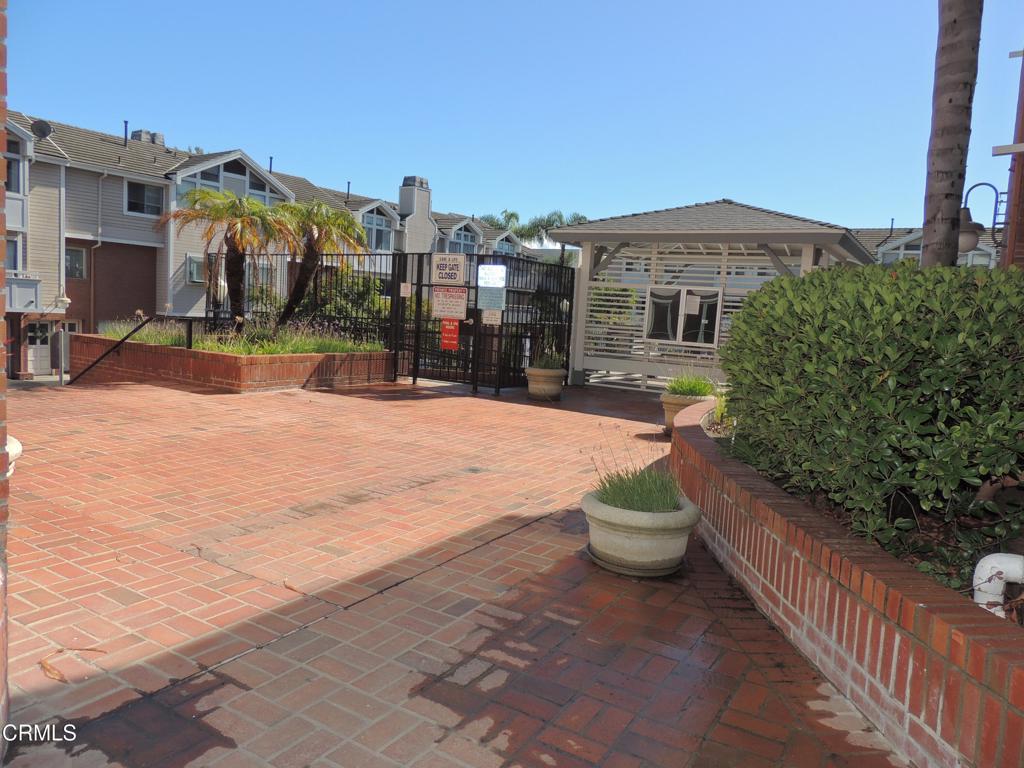 865 South B Street, Unit L2 Oxnard, CA 93030 - Photo 27 of 32 a view of a white house with a yard