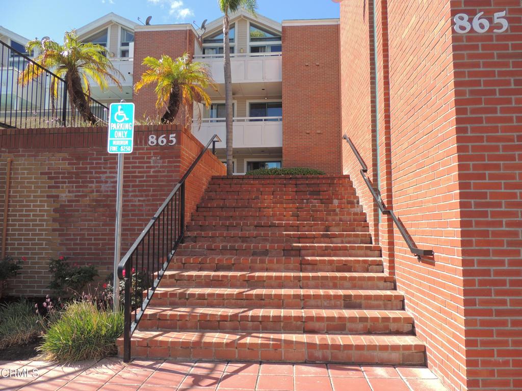 865 South B Street, Unit L2 Oxnard, CA 93030 - Photo 28 of 32 a front view of a house with a yard
