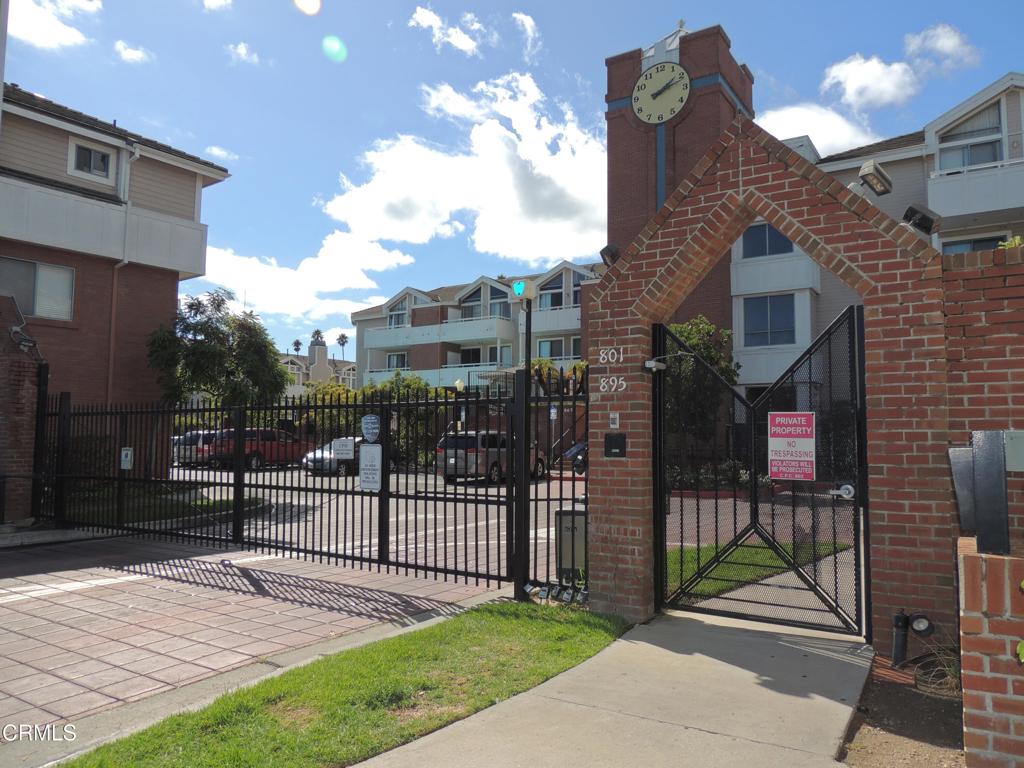 865 South B Street, Unit L2 Oxnard, CA 93030 - Photo 29 of 32 a view of a brick house with a small yard and plants