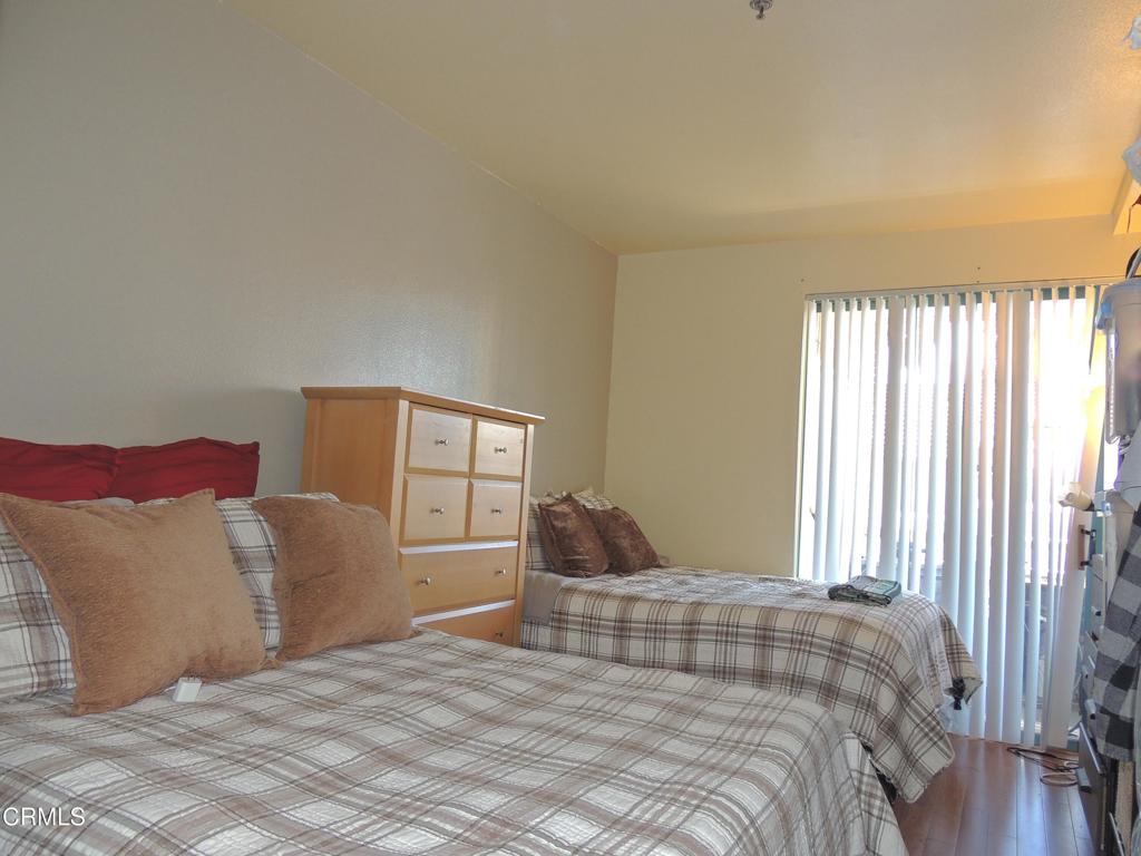 865 South B Street, Unit L2 Oxnard, CA 93030 - Photo 8 of 32 a bedroom with a bed and a window
