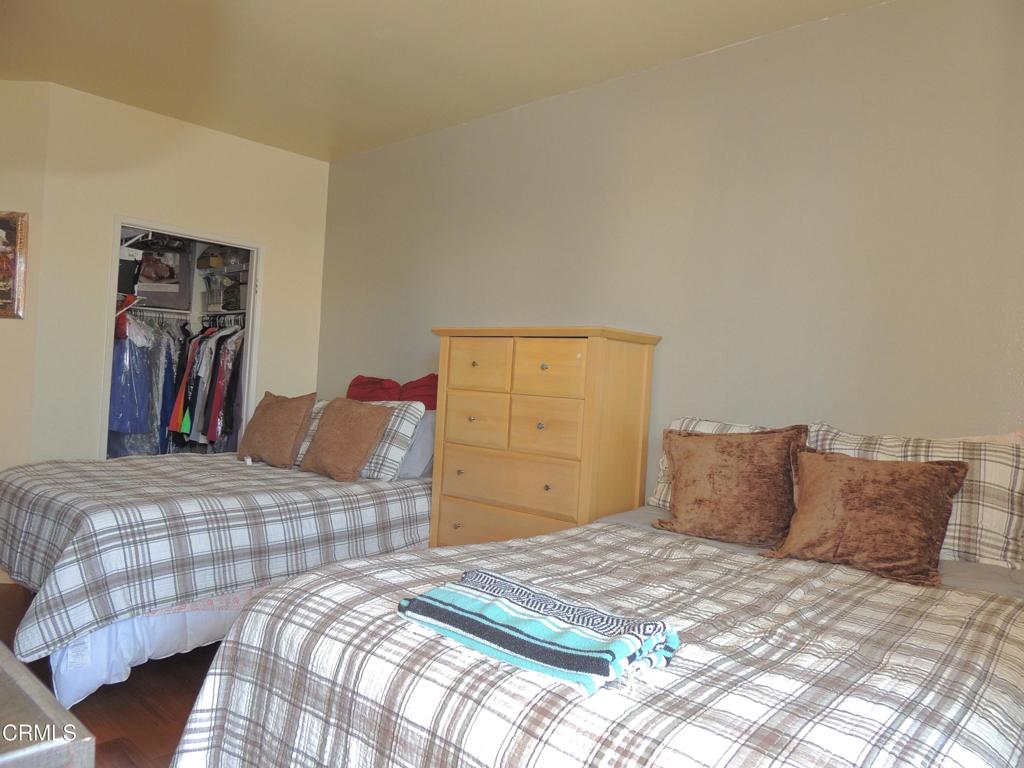 865 South B Street, Unit L2 Oxnard, CA 93030 - Photo 10 of 32 a bedroom with a bed and a closet