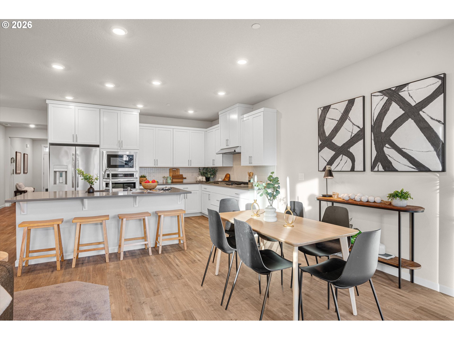 2637 South 6th Way Ridgefield, WA 98642 - Photo 17 of 41 a kitchen with stainless steel appliances kitchen island granite countertop a dining table chairs and view living room