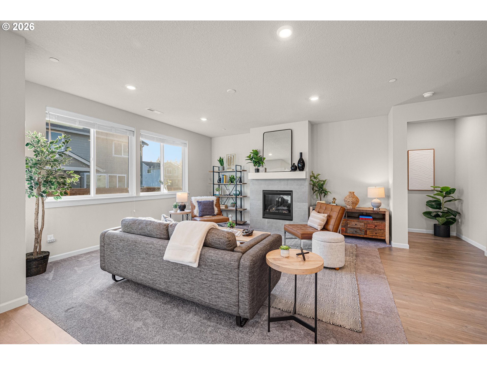 2637 South 6th Way Ridgefield, WA 98642 - Photo 9 of 41 a living room with furniture a fireplace and a large window