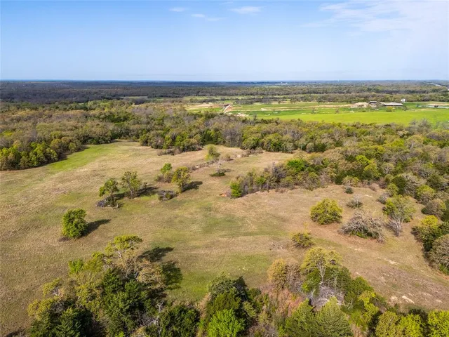 a view of a lake with a house in a yard