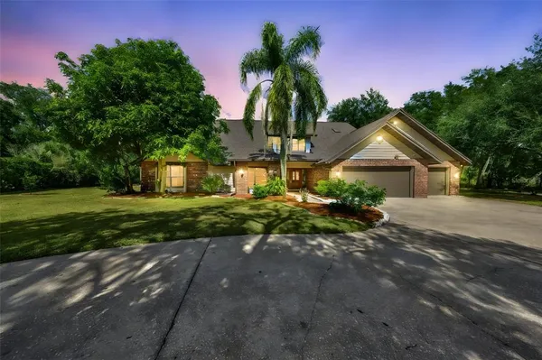 a front view of house with yard and green space