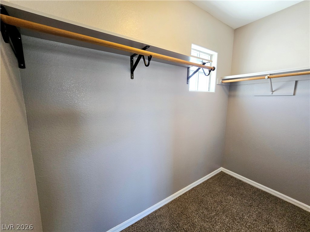 3759 Funston Way Las Vegas, NV 89129 - Photo 10 of 31 An organized walk-in closet with ample hanging space and natural light from a privacy window.