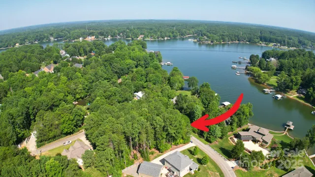 an aerial view of residential house with outdoor space and lake view