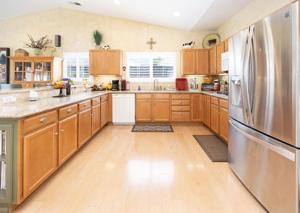 265 Blueridge Street Soledad, CA 93960 - Photo 12 of 33 a kitchen with granite countertop a refrigerator and white cabinets