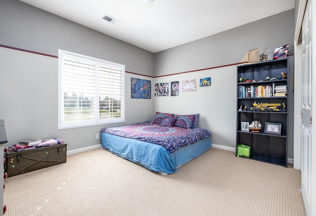 265 Blueridge Street Soledad, CA 93960 - Photo 24 of 33 a bedroom with a bed cabinets and window