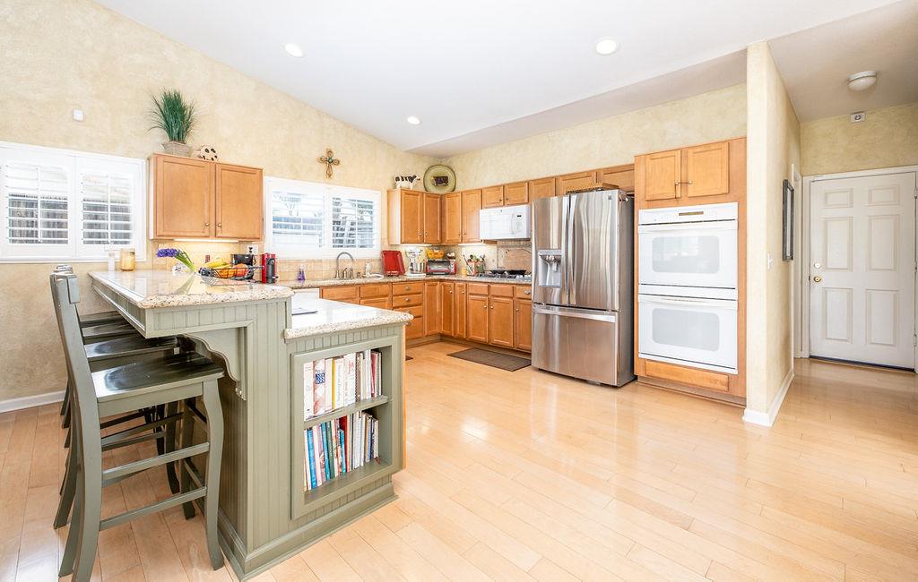 265 Blueridge Street Soledad, CA 93960 - Photo 10 of 33 a kitchen with stainless steel appliances a refrigerator a stove a sink and a dining table with wooden floor