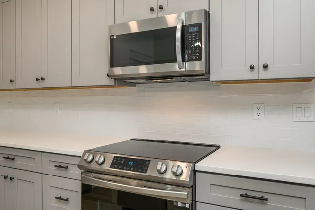 a stove top oven sitting inside of a kitchen