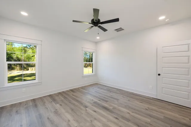 wooden floor in an empty room with a window