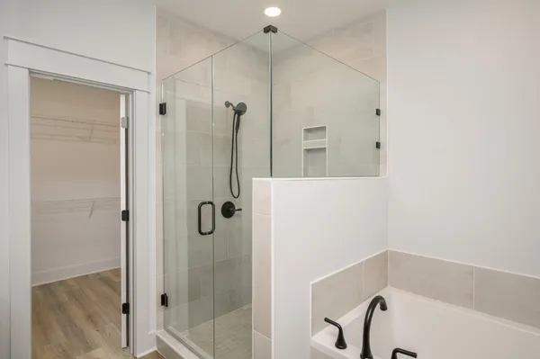a bathroom with a bathtub and a shower