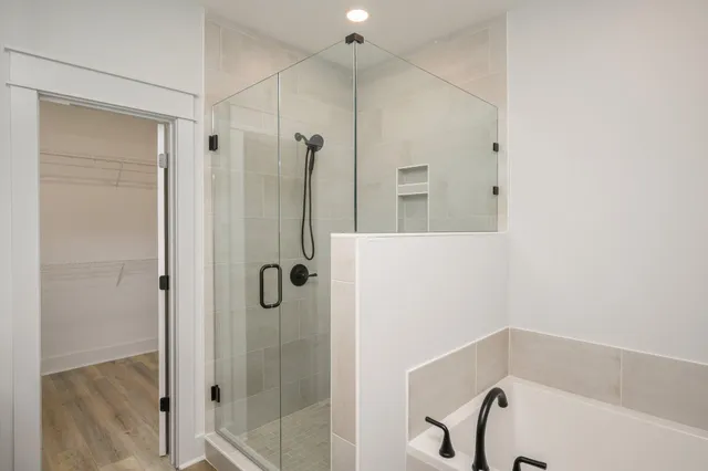 a bathroom with a bathtub and a shower