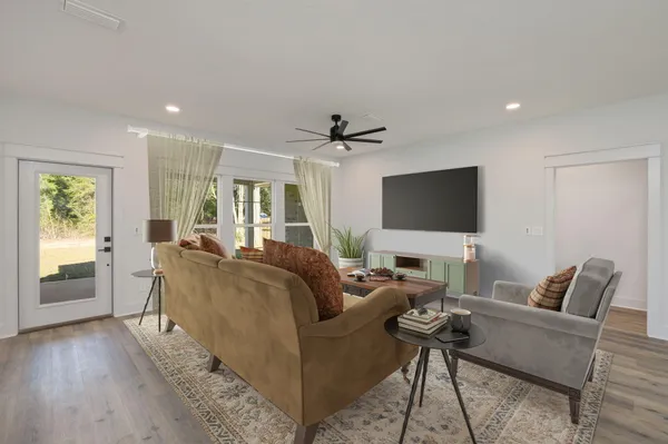 a living room with furniture and a flat screen tv