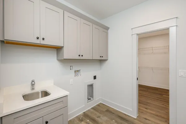 a view of a kitchen with white cabinets and a sink