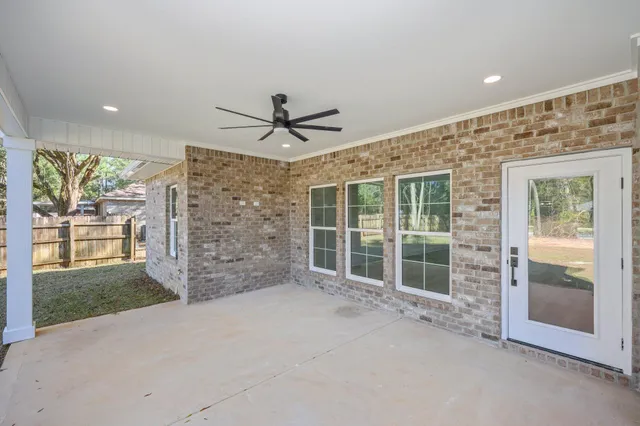 a view of a livingroom with a ceiling fan and window