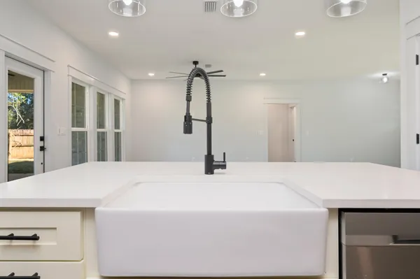 a room with a bed and chandelier