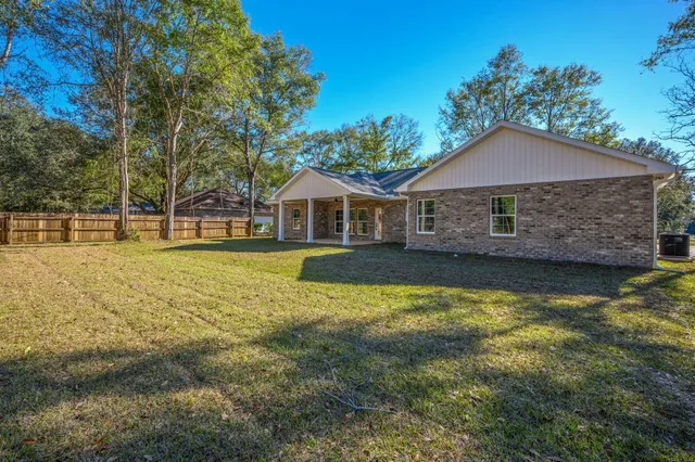 a house with swimming pool in front of it