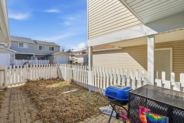 a view of a house with a wooden fence