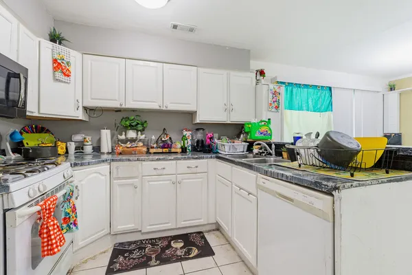 a kitchen with stainless steel appliances a sink a stove and cabinets