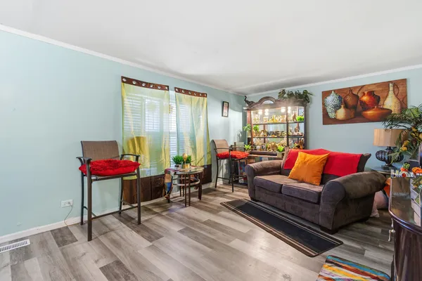 a living room with furniture and wooden floor