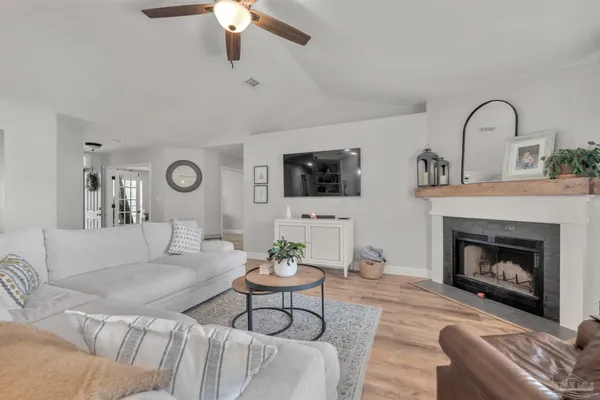 a kitchen with stainless steel appliances granite countertop a sink a stove and a wooden floors