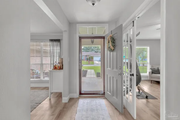 a living room with furniture fireplace and window