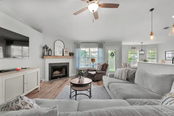 a living room with furniture a window and a fireplace