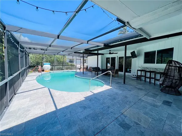 a view of a backyard with a patio and a garden