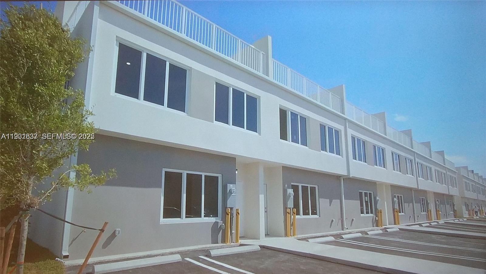 25810 Southwest 144th Avenue Homestead, FL 33032 - Photo 2 of 9 a front view of a building with a traffic signal