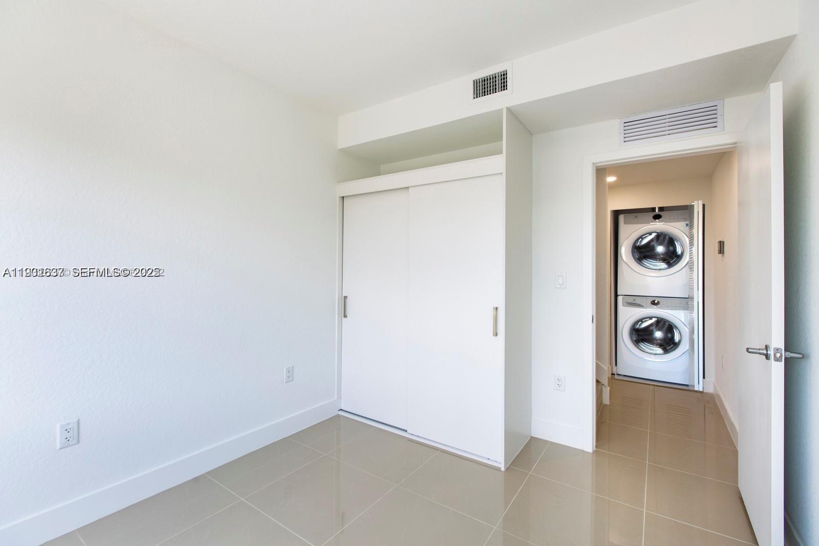 25810 Southwest 144th Avenue Homestead, FL 33032 - Photo 4 of 9 a view of a storage & utility room with a washer and dryer