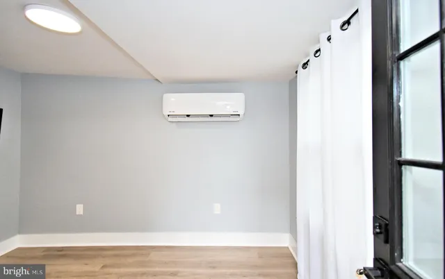 a view of a room with wooden floor and cabinet