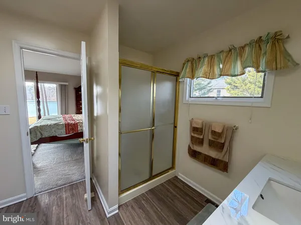 a bathroom with a tub a sink and a mirror