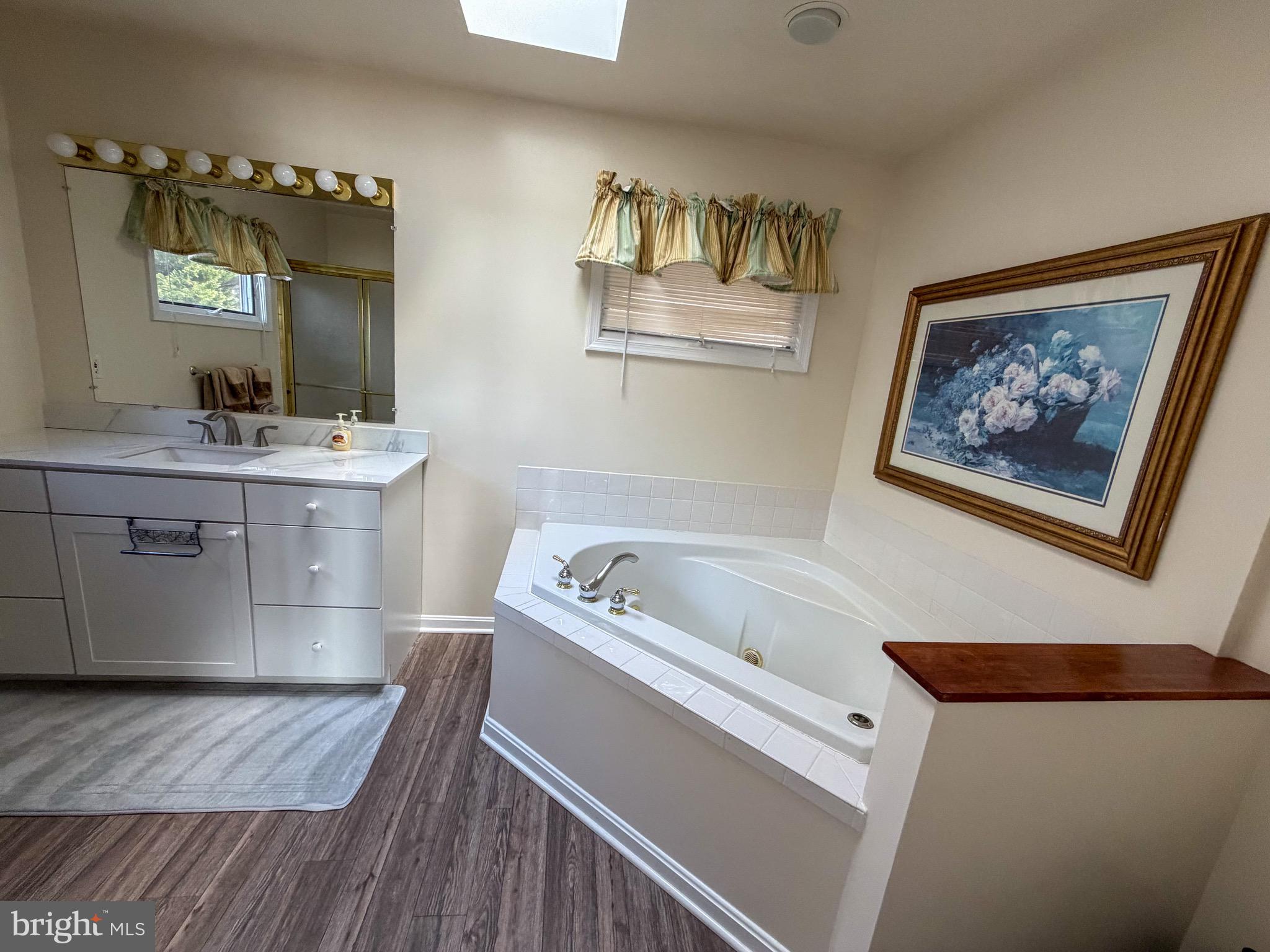 3300 Viola Way Bumpass, VA 23024 - Photo 13 of 36 a bathroom with a tub a sink and a mirror
