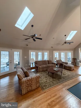 a living room with fireplace furniture and a wooden floor