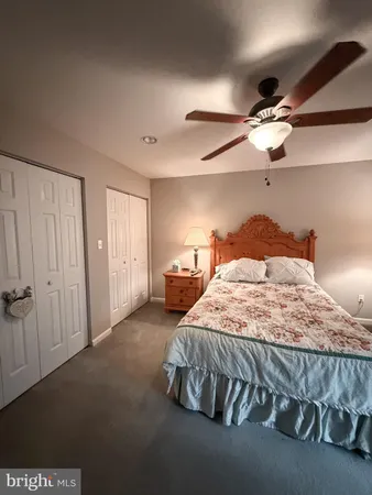 a spacious bedroom with a bed and a chandelier