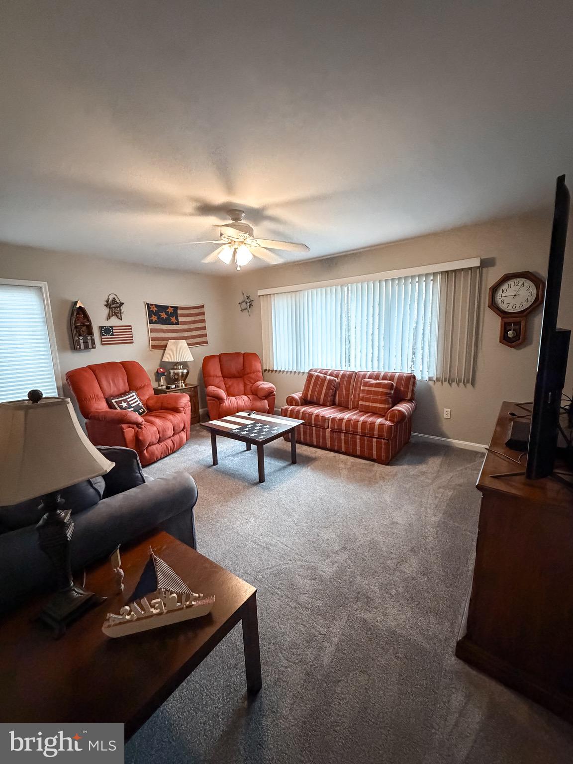 3300 Viola Way Bumpass, VA 23024 - Photo 30 of 36 a living room with furniture a rug and a flat screen tv