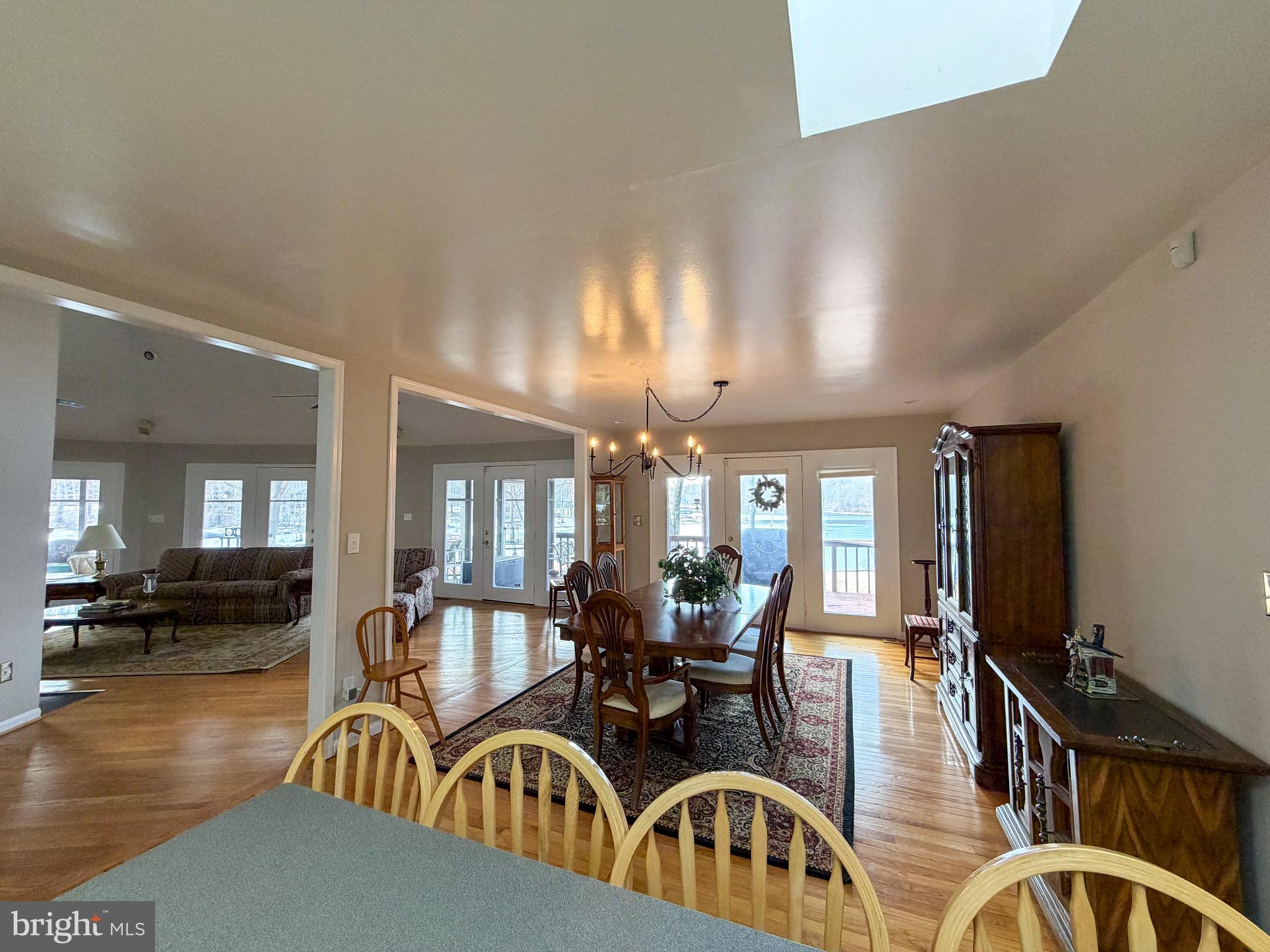 3300 Viola Way Bumpass, VA 23024 - Photo 8 of 36 a view of a a dining room and livingroom with furniture wooden floor a chandelier