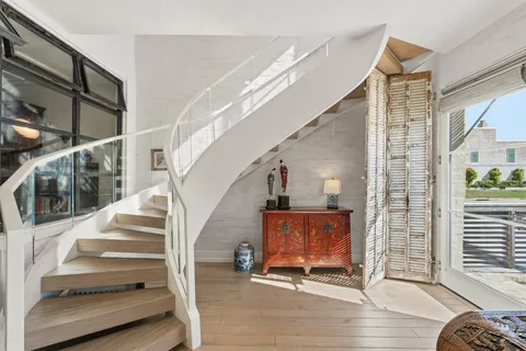 a view of entryway livingroom and hall with wooden floor
