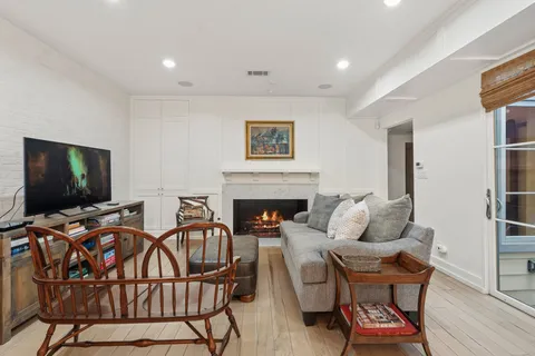 a living room with furniture a flat screen tv and a fireplace