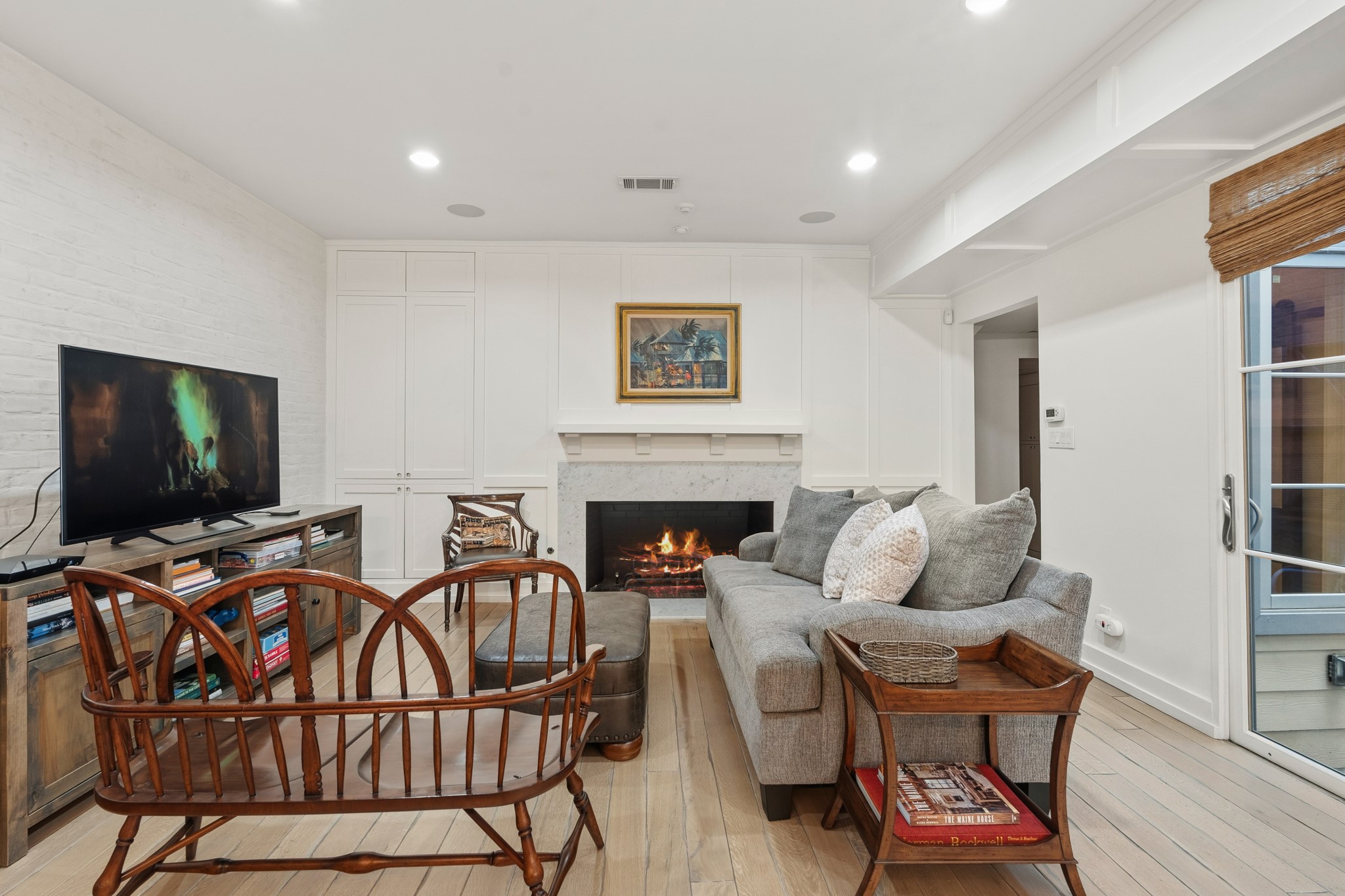 7606 Del Monte Drive Houston, TX 77063 - Photo 8 of 17 Den with fireplace anchors the open living, dining, and kitchen areas.