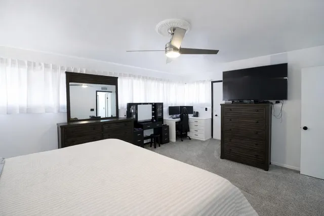 a bedroom with furniture and a flat screen tv