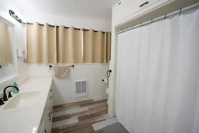 a bathroom with a shower curtain and a sink