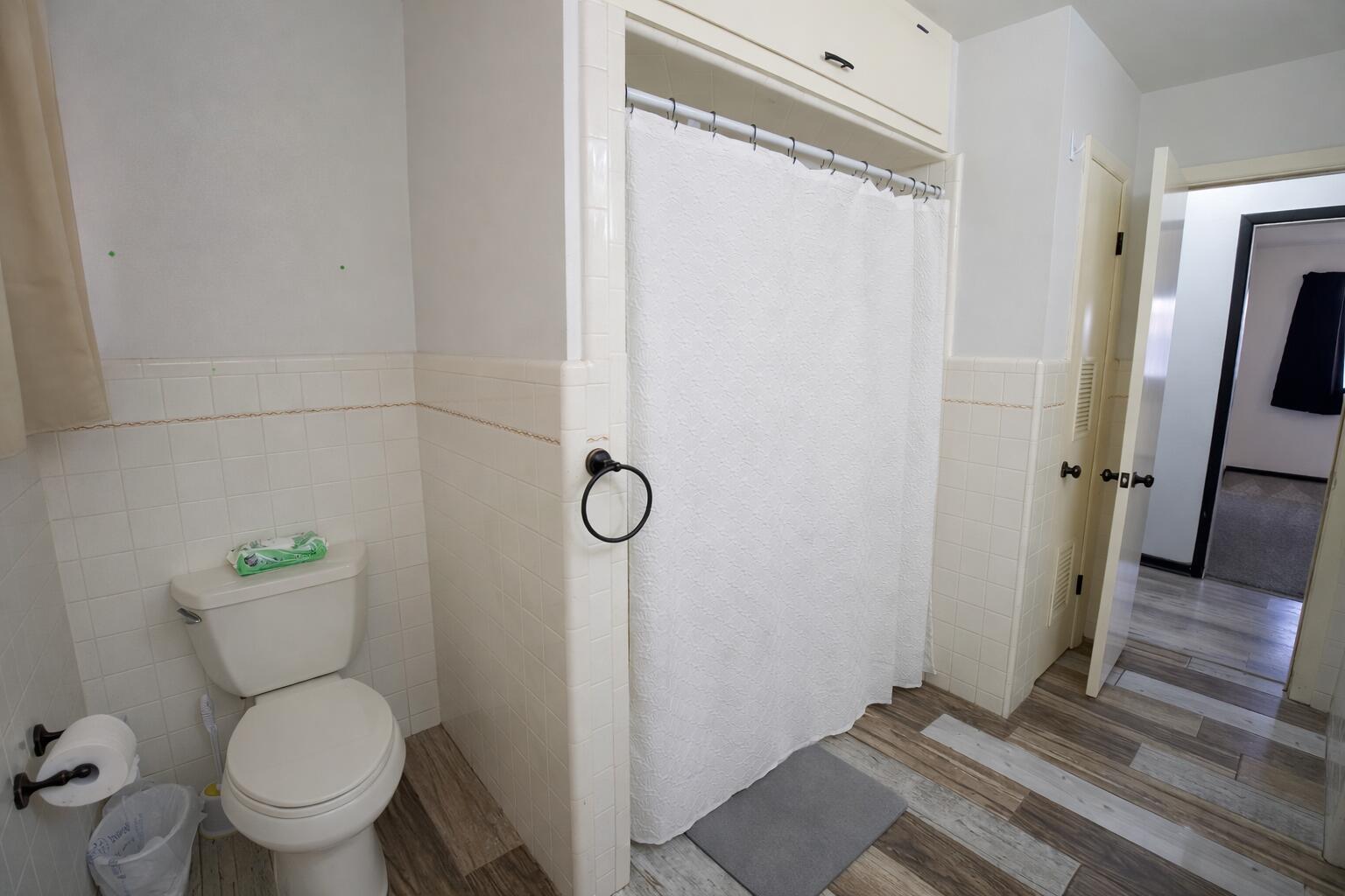 730 South 17th Street Slaton, TX 79364 - Photo 14 of 23 a white toilet sitting next to a bathroom sink